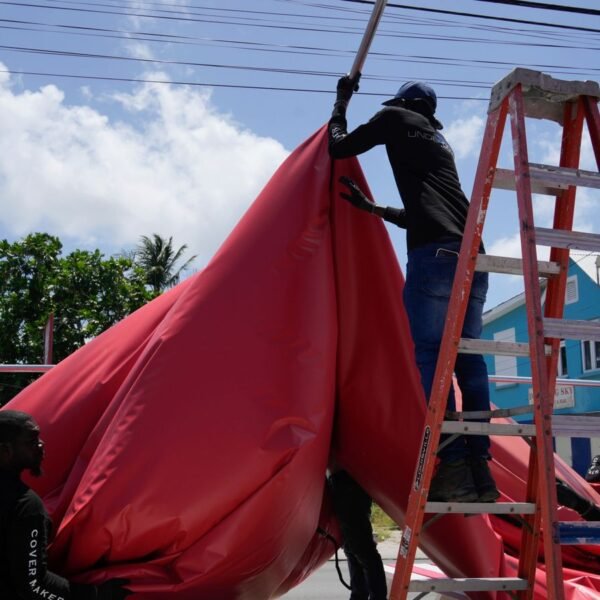 People disassemble a beach bar's awning in preparation for Hurricane Beryl, in Bridgetown, Barbados, Sunday, June 30, 2024. (AP Photo/Ramon Espinosa)