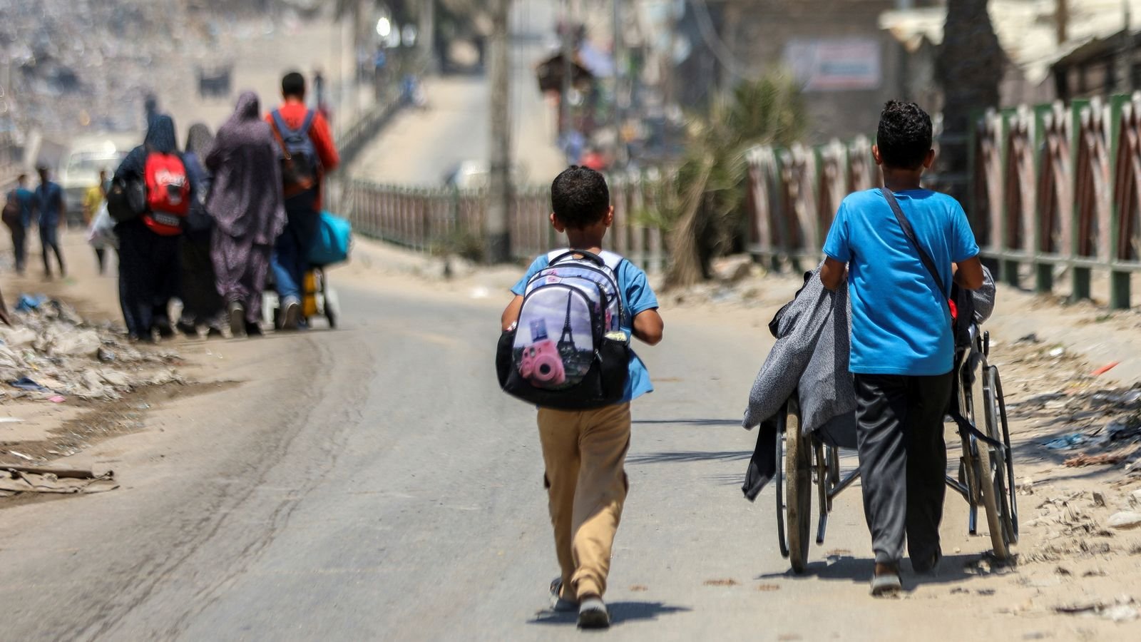Children leaving Shejaia. Pic: Reuters
