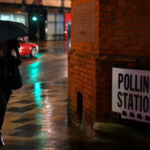 A woman walks in the rain outside a polling station in London, during the 2019 general election. Pic: Reuters