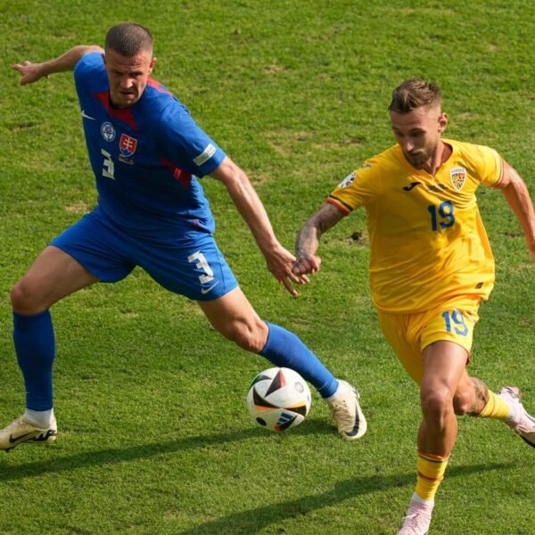 Romania's Denis Dragus, right, and Slovakia's Denis Vavro vie for the ball during a Group E match at the Euro 2024 soccer tournament in Frankfurt, Germany, Wednesday, June 26, 2024. (AP Photo/Darko Vojinovic)