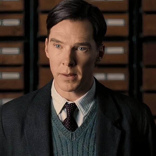 Alan wears a blue sweater vest in The Imitation Game